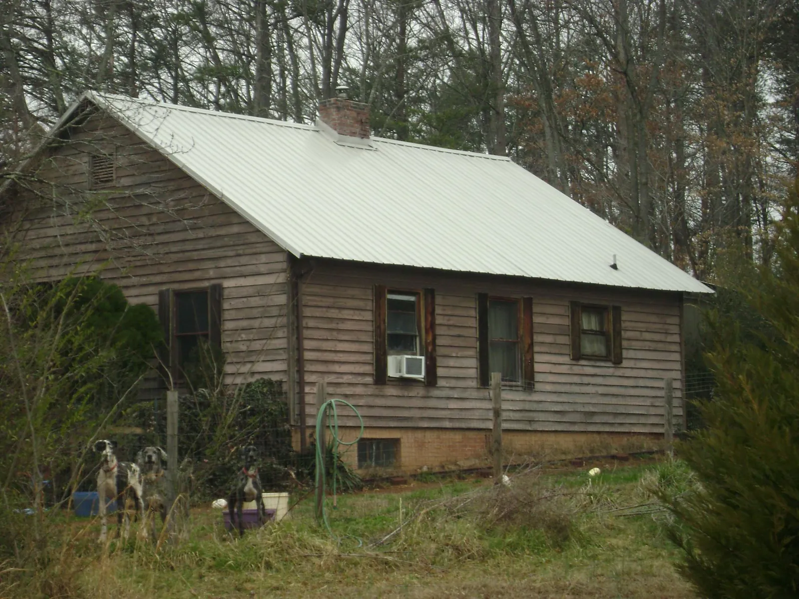 White metal roof on an old wood sided farmhouse, from a Asphalt Shingle Roof Repair job in Mechanicsville